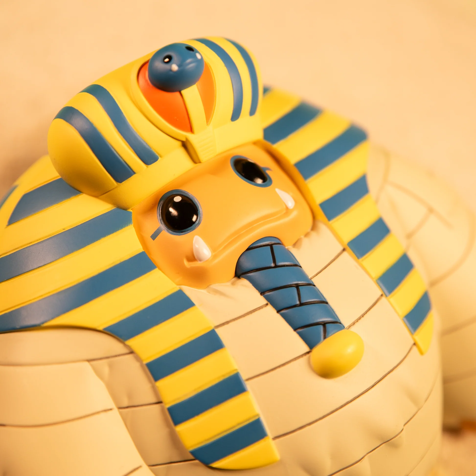 Tut Chomp close-up of the face, blue beard and blue-and-yellow headdress